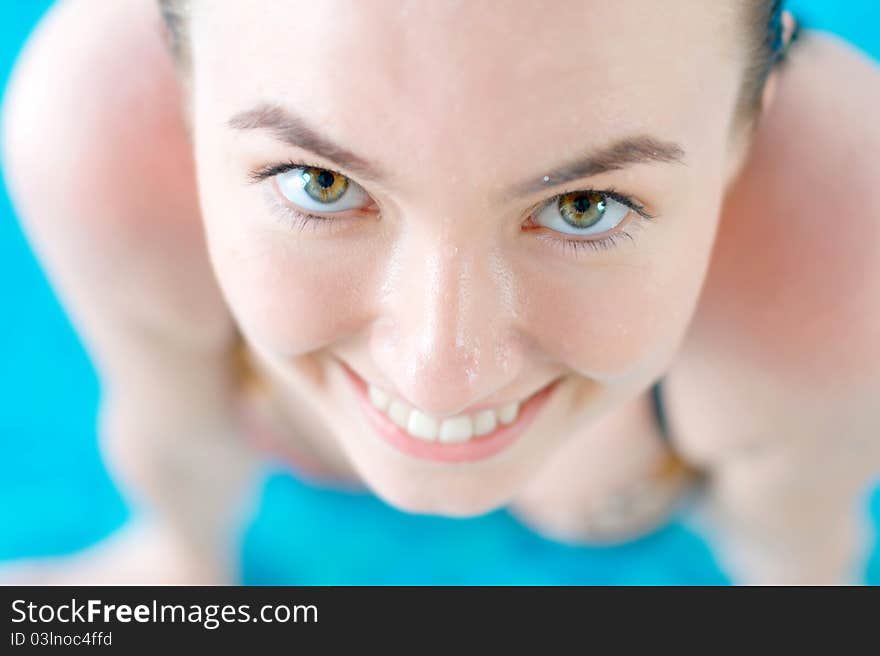 Close-up portrait of a smiling girl in a swimming pool with copy space. Close-up portrait of a smiling girl in a swimming pool with copy space