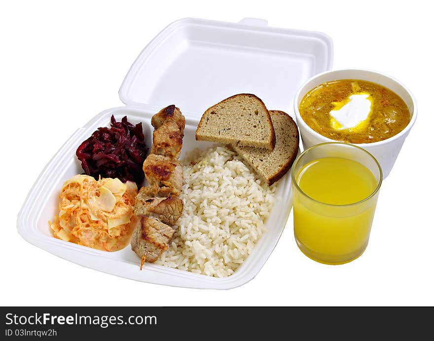 Dinner set to take away. Rice, shashlik, salads, cabbage soup and juice. Isolated on white background.