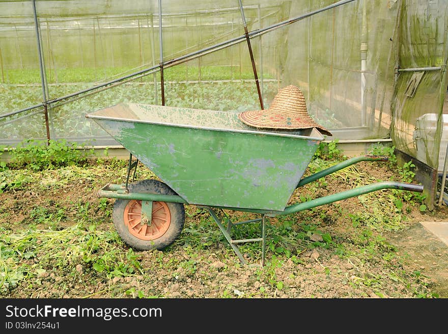 Wheel Barrow And Farmer Straw Hat