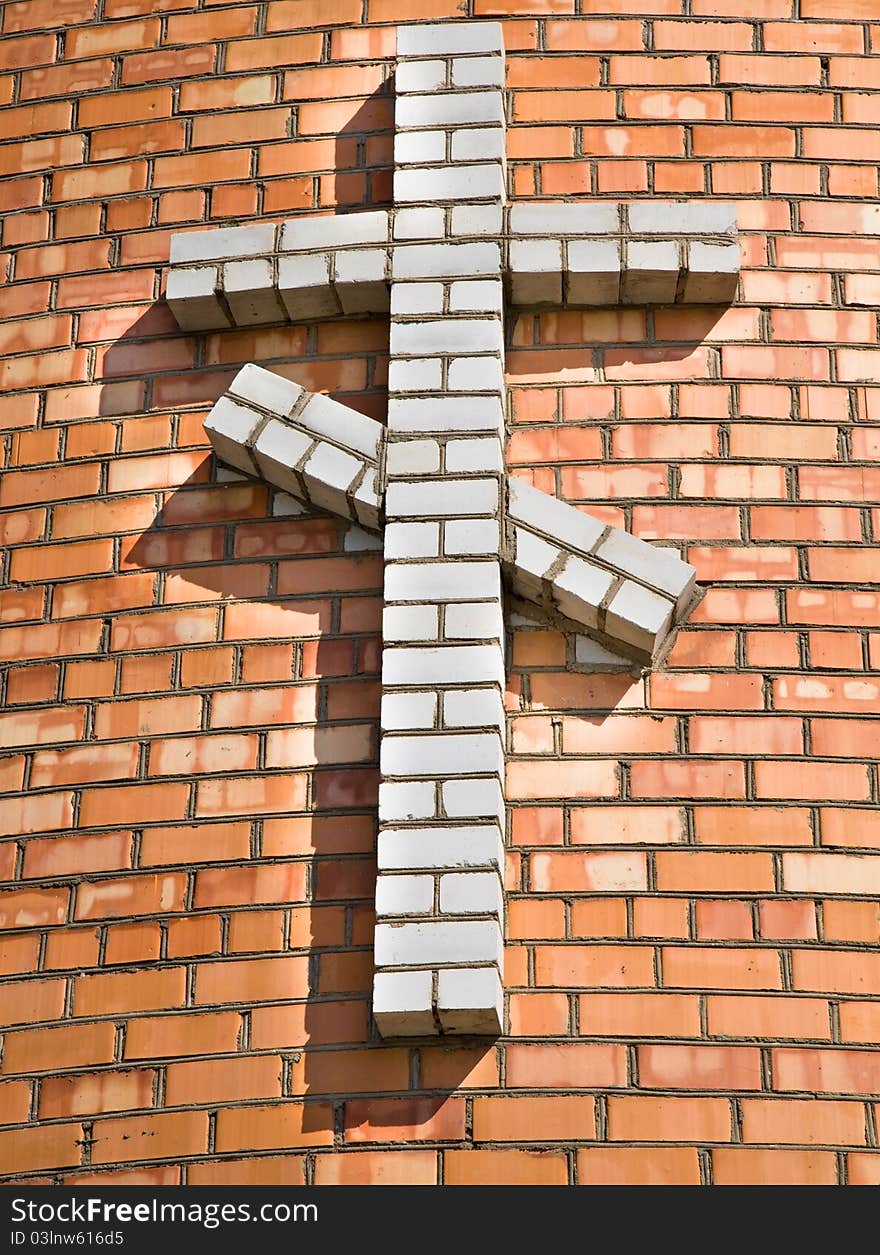 Cross combined from bricks on a brick wall (on a building of orthodox church). Cross combined from bricks on a brick wall (on a building of orthodox church)