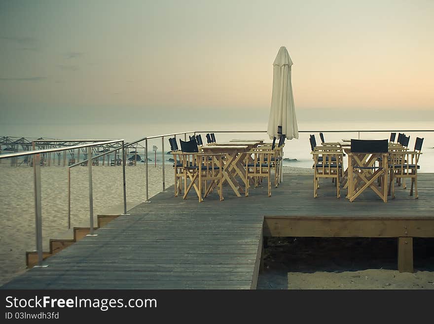 This photograph depicts the end of a day on the terrace over the sand beach in Portugal. This photograph depicts the end of a day on the terrace over the sand beach in Portugal.