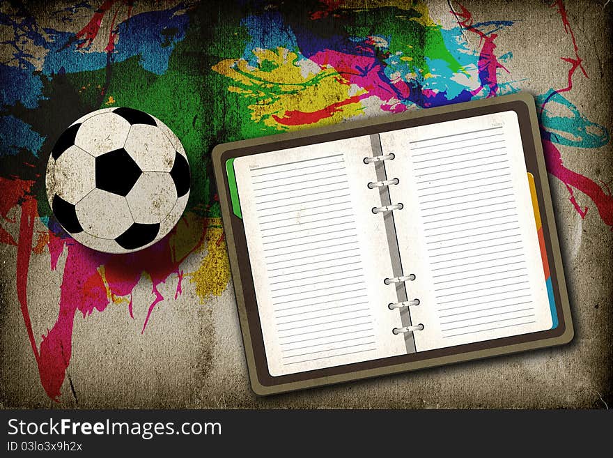 Football and blank notebook on vintage background