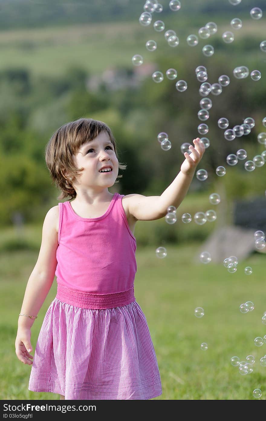 Pretty child catching balloons