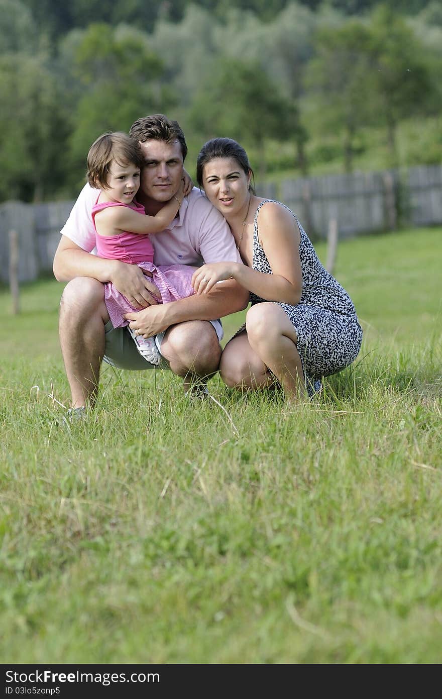 Happy Family Relaxing In Nature