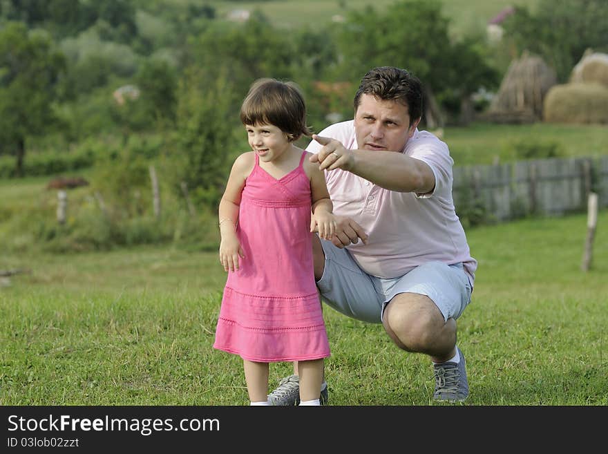 Young father teaching his little girl in summer season. Young father teaching his little girl in summer season