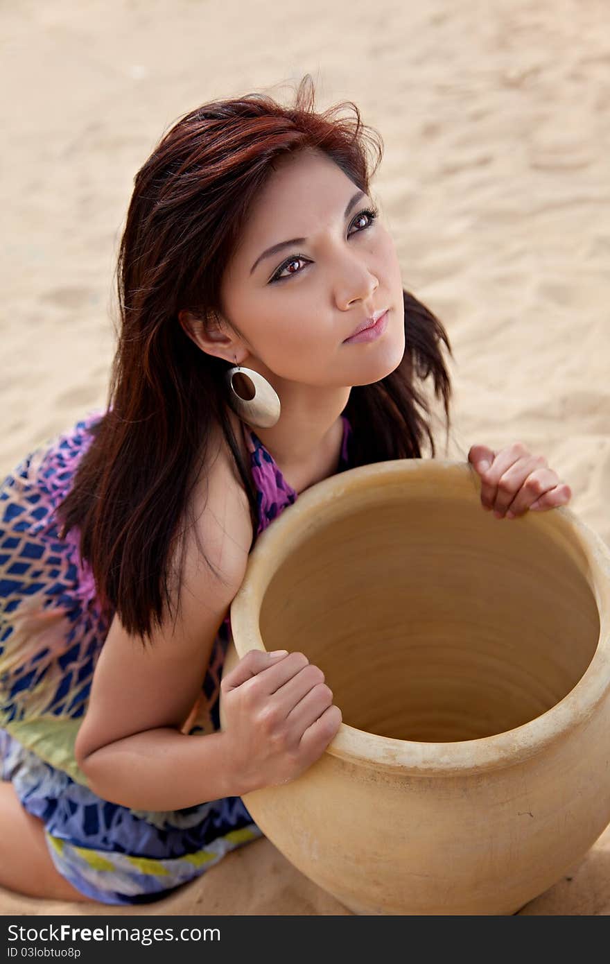 Female holding a large clay pot