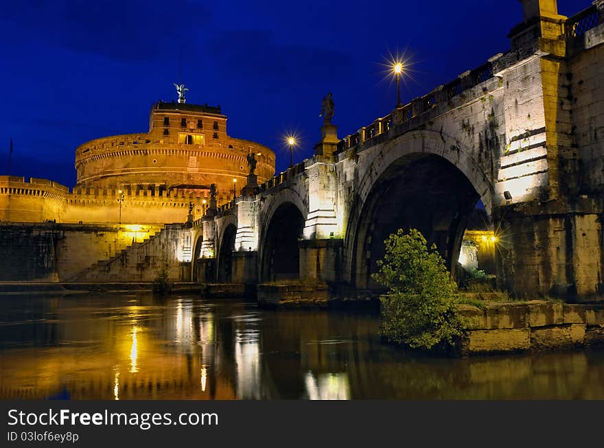 Bridge crossing the river Tiber and Castle Sant'Angelo illuminated at night. Bridge crossing the river Tiber and Castle Sant'Angelo illuminated at night