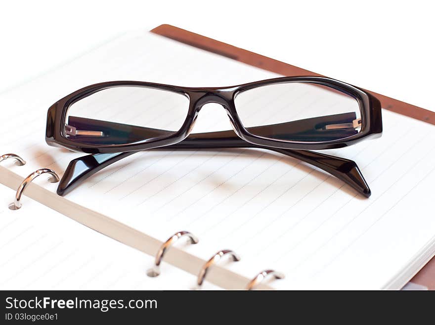 Eyeglasses with Notebook on a white background. Eyeglasses with Notebook on a white background