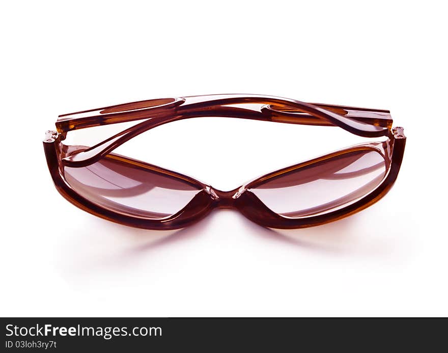 Brown folded fashion sunglasses isolated on white background