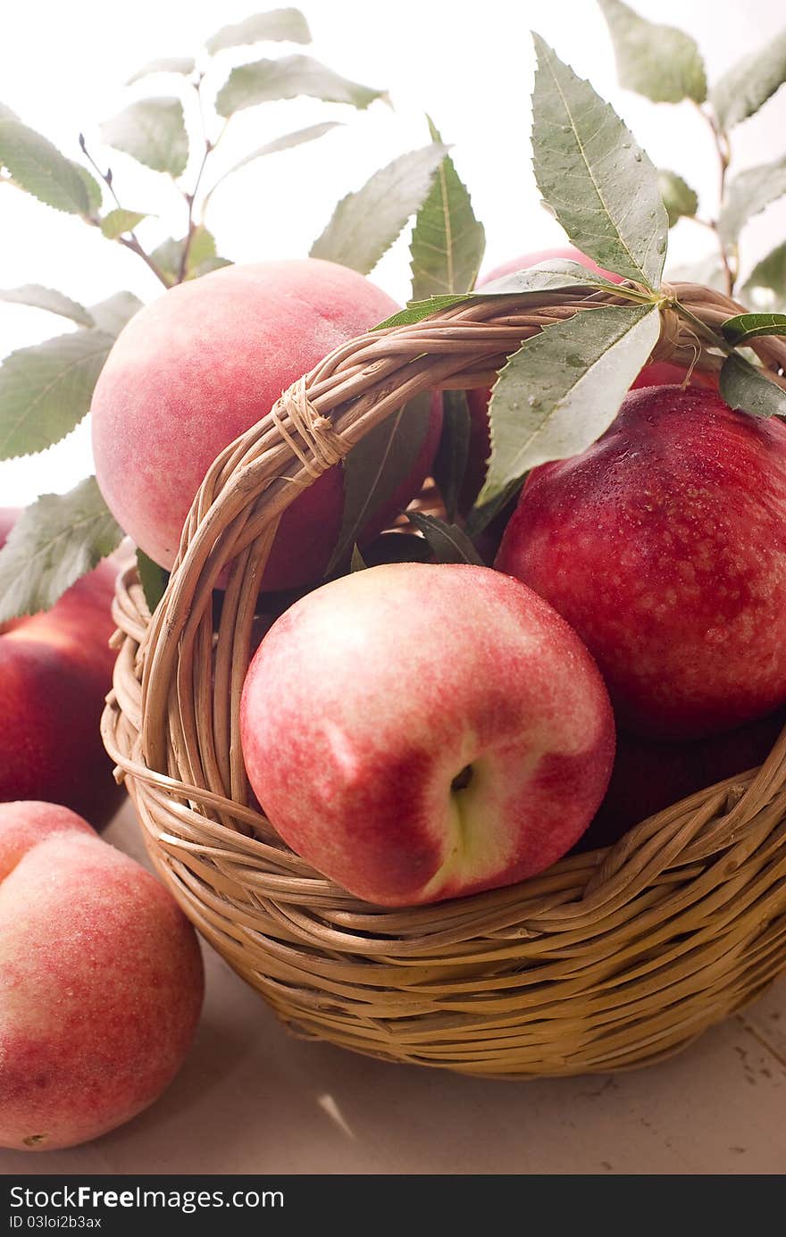 Fresh peaches with green leaves