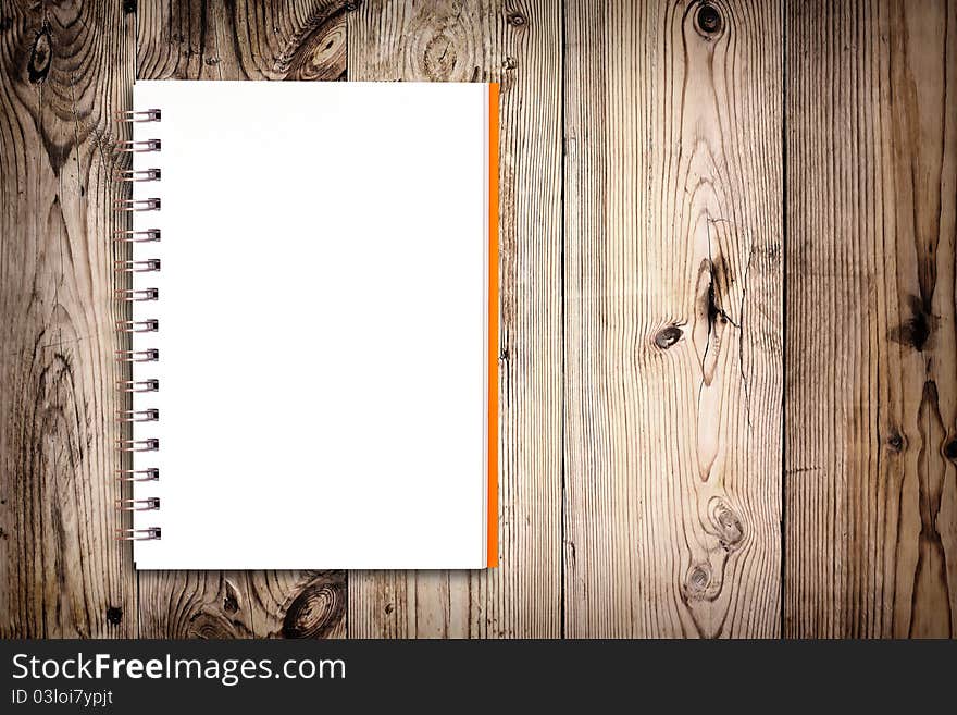 White notebook on wooden background