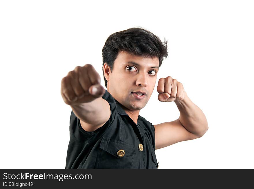 Angry Indian man in attacking position in extreme rage over white background