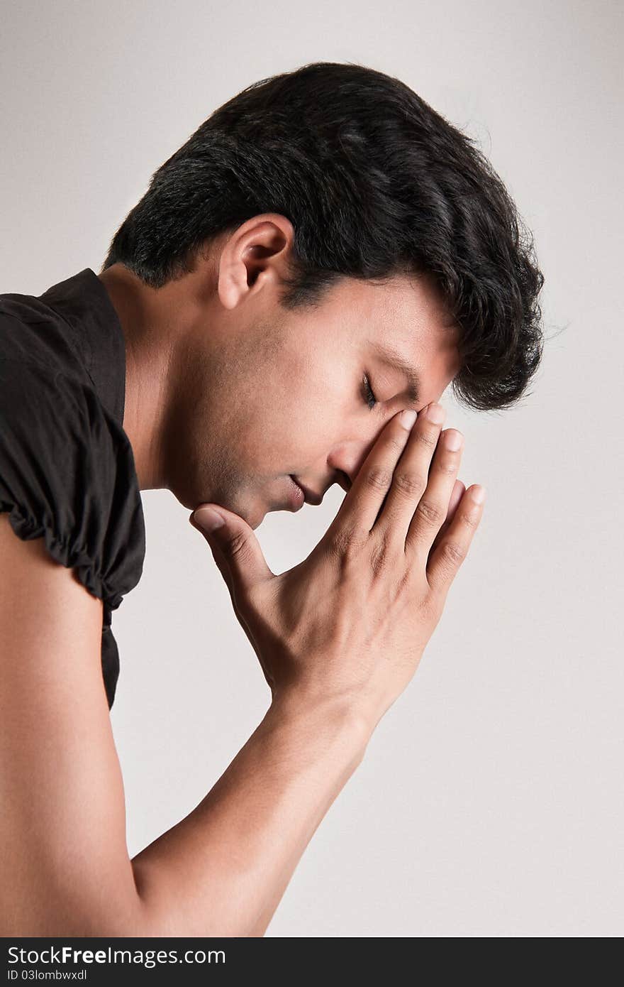 Indian man in the position of thinking his head supported by hand and closed eyes. Indian man in the position of thinking his head supported by hand and closed eyes