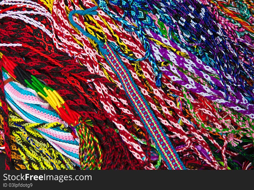 A pile of colorful ribbons with different woven patterns