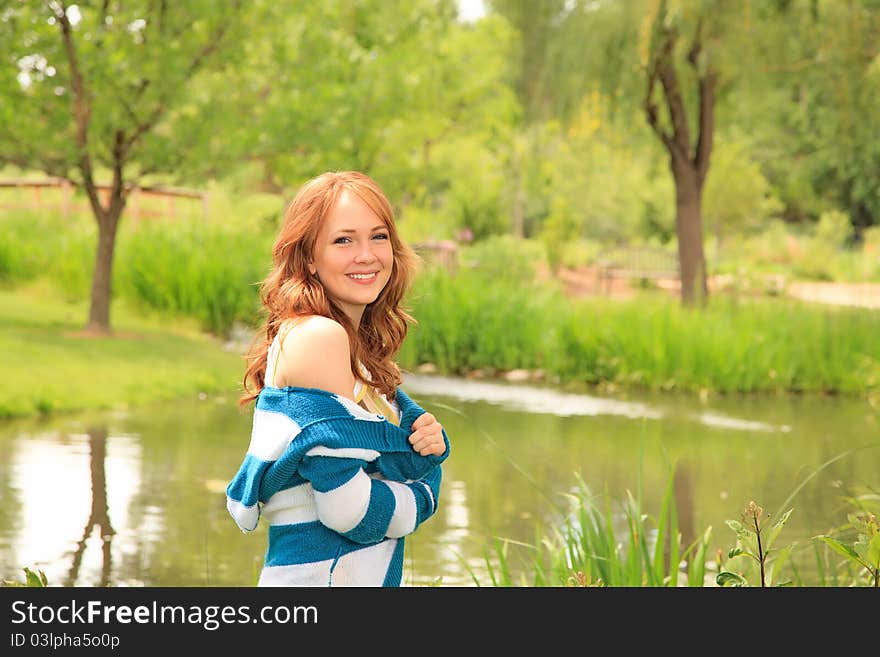 Girl walking by the pond