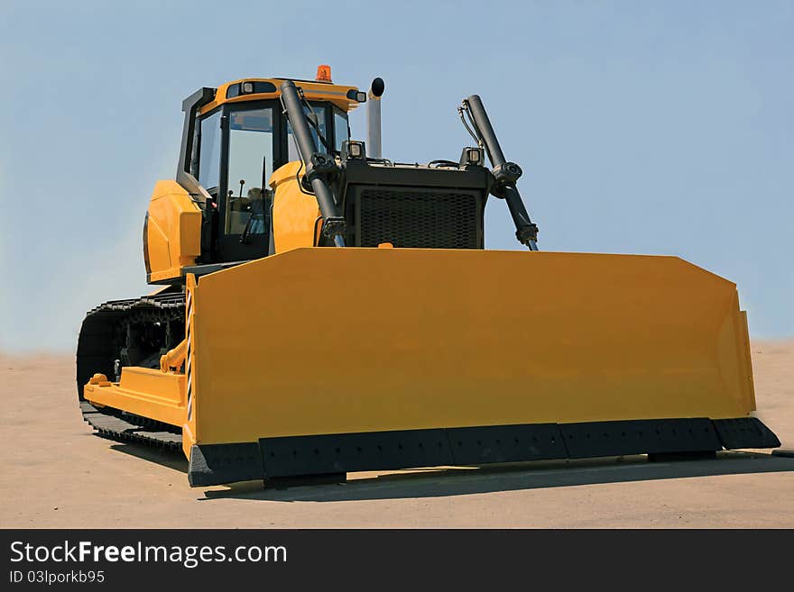 A large yellow bulldozer at a construction site