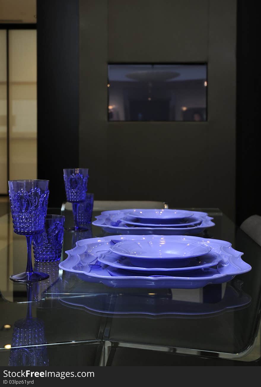 Table setting with violet glasswine and plates. Table setting with violet glasswine and plates.