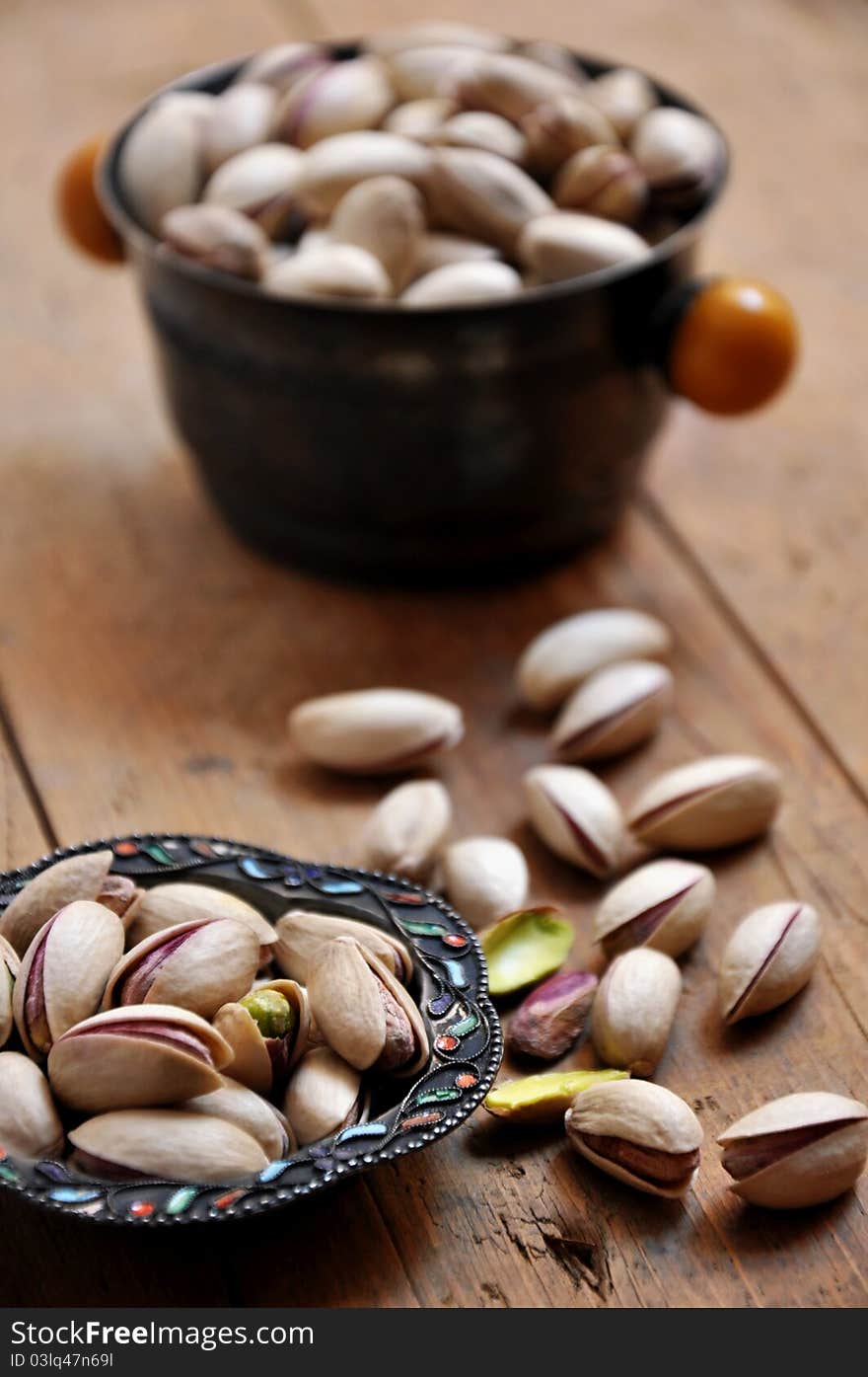 Pistachios on natural wooden table background