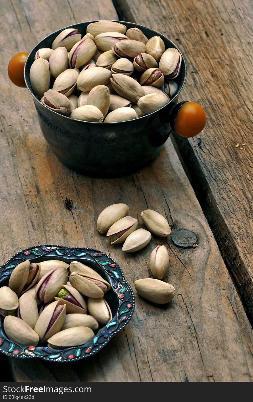 Pistachios on natural wooden table background