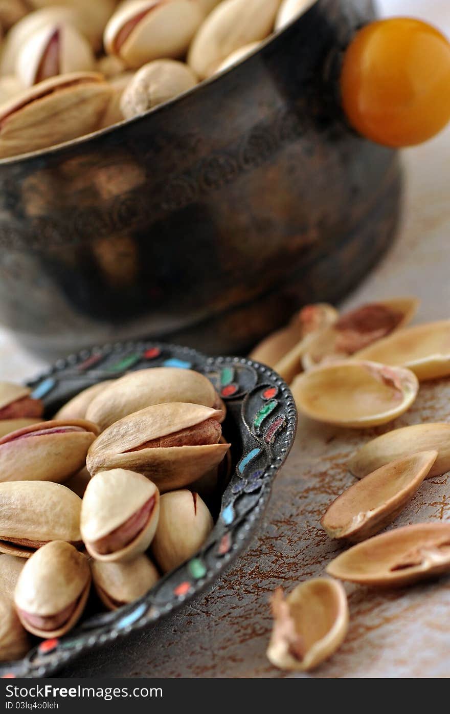 Pistachios on natural wooden table background