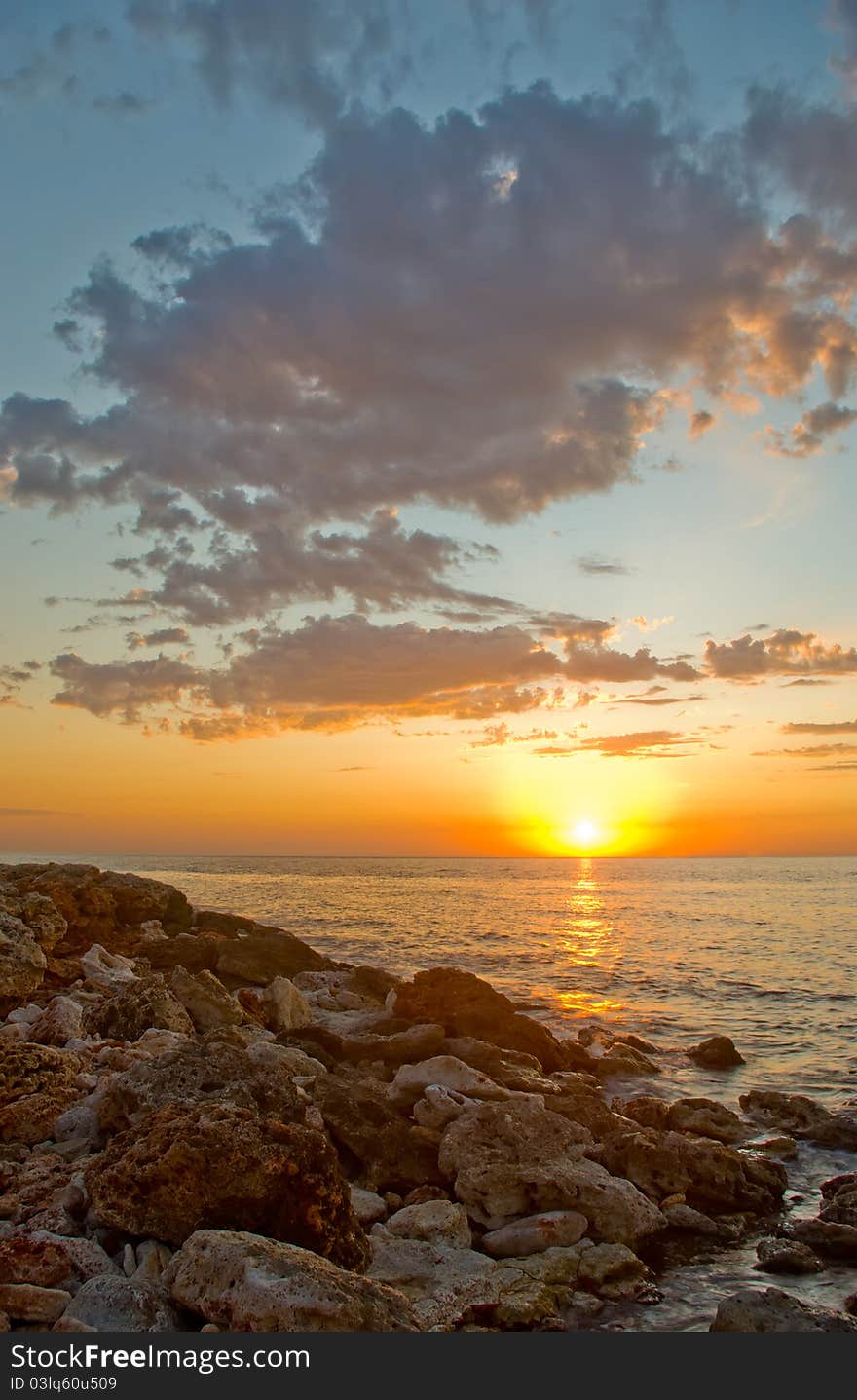 Beautiful sunset against the sea and rocks. Beautiful sunset against the sea and rocks