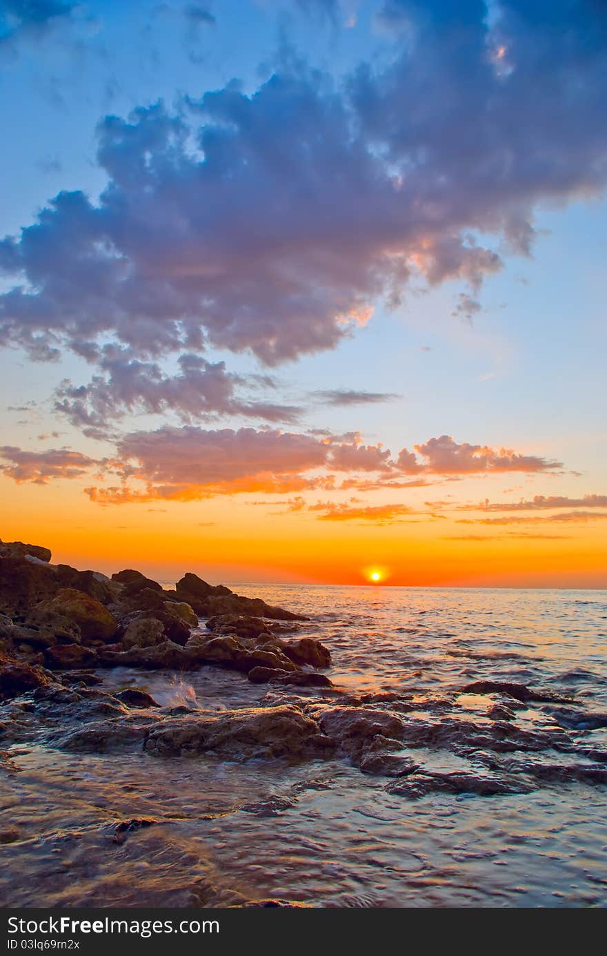 Beautiful sunset against the sea and rocks. Beautiful sunset against the sea and rocks