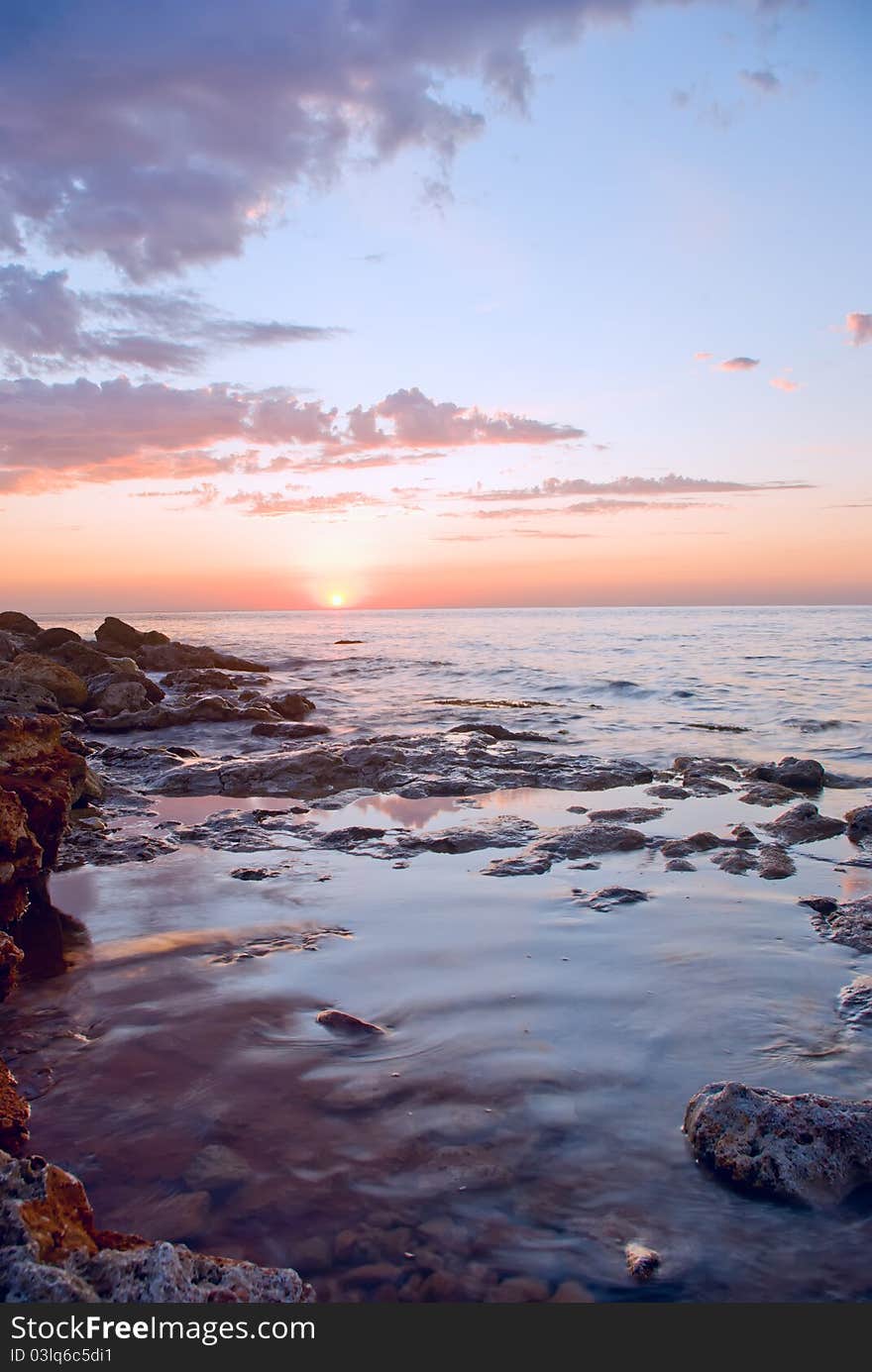 Beautiful sunset against the sea and rocks. Beautiful sunset against the sea and rocks