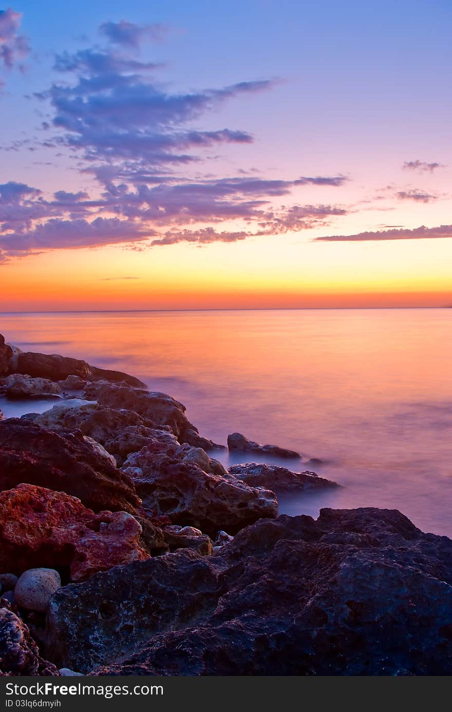 Beautiful sunset against the sea and rocks. Beautiful sunset against the sea and rocks