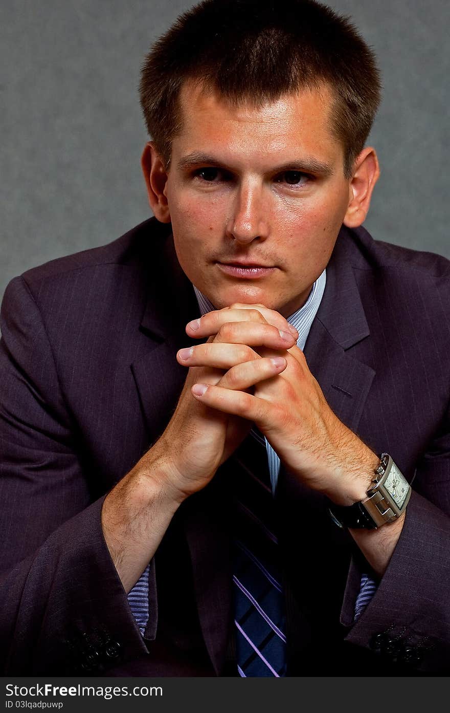 Businessman working a financial strategy out against the grey background. Businessman working a financial strategy out against the grey background