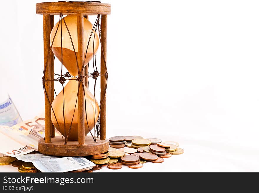 Old hourglass (made in India, XIX century) with euros. Old hourglass (made in India, XIX century) with euros