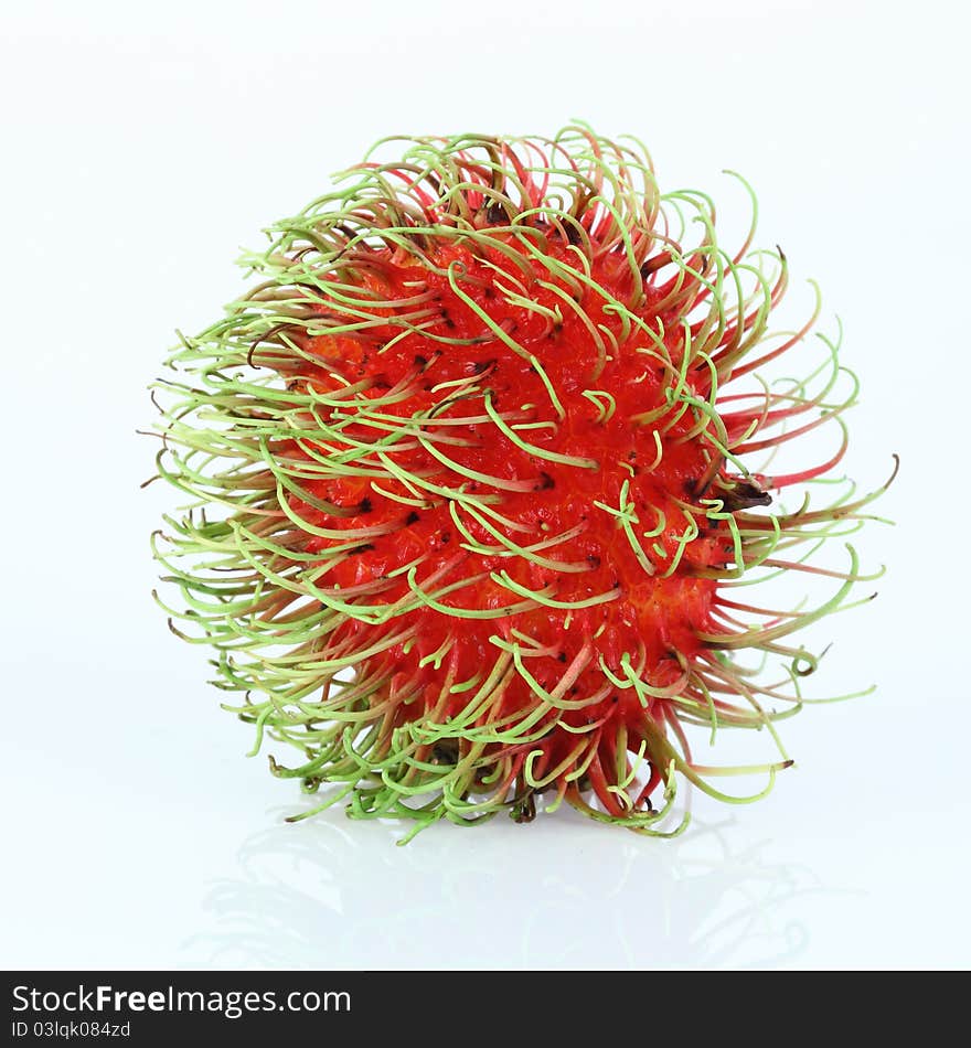 Single rambutan on white background