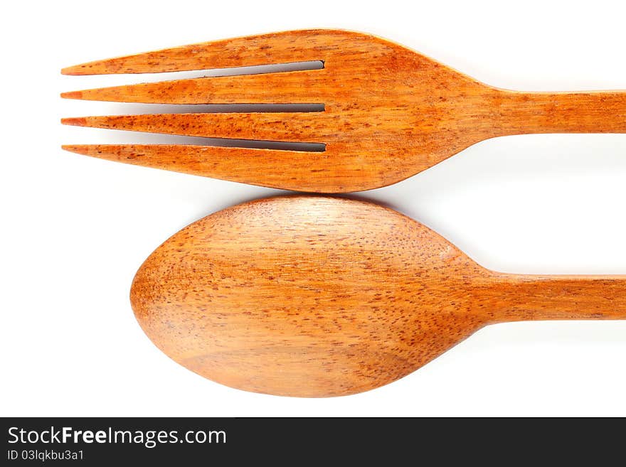 Spoon and fork produces from the wood on white background. Spoon and fork produces from the wood on white background