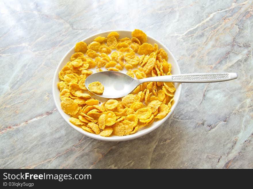 Bowl of cereal with milk on stone background. Bowl of cereal with milk on stone background