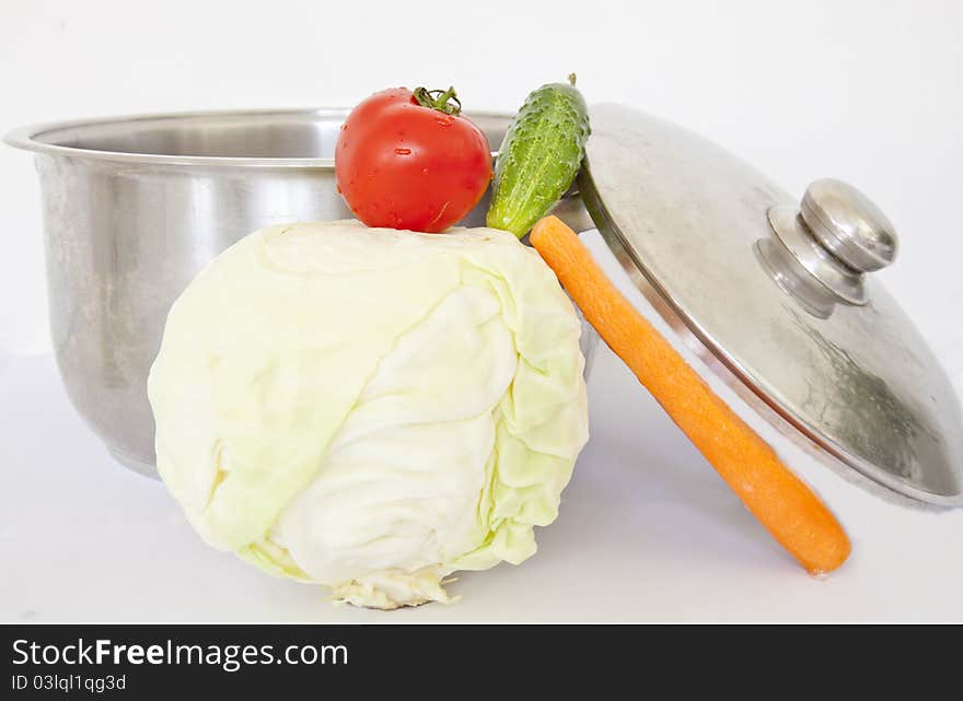 Vegetable colection set up near a cooking pot