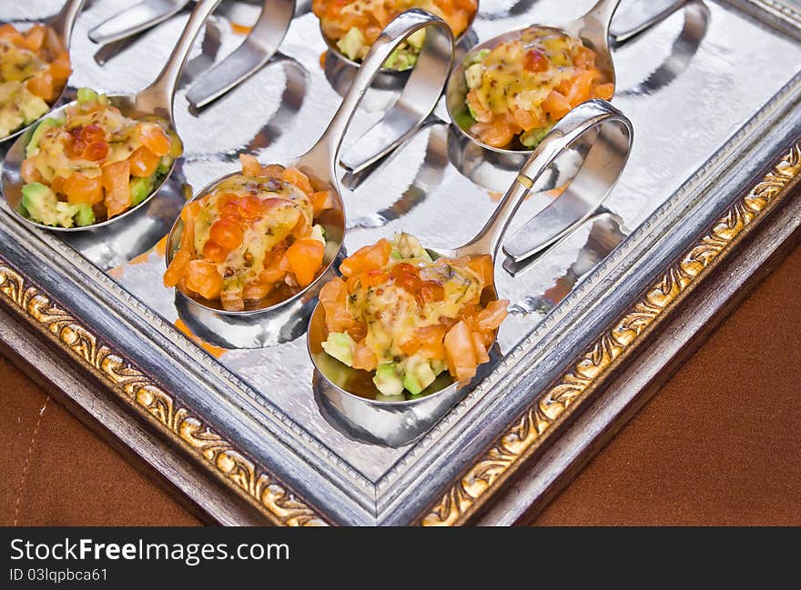 Spoon with delicious salad on frame