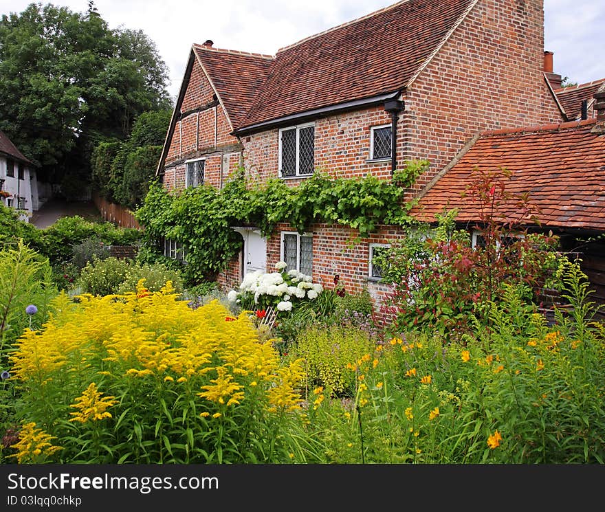 Traditional English Village Cottage full of colorful Summer Flowers. Traditional English Village Cottage full of colorful Summer Flowers