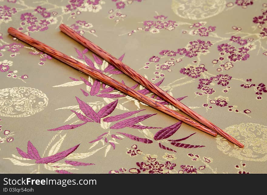 Coconut chopsticks on fabric background