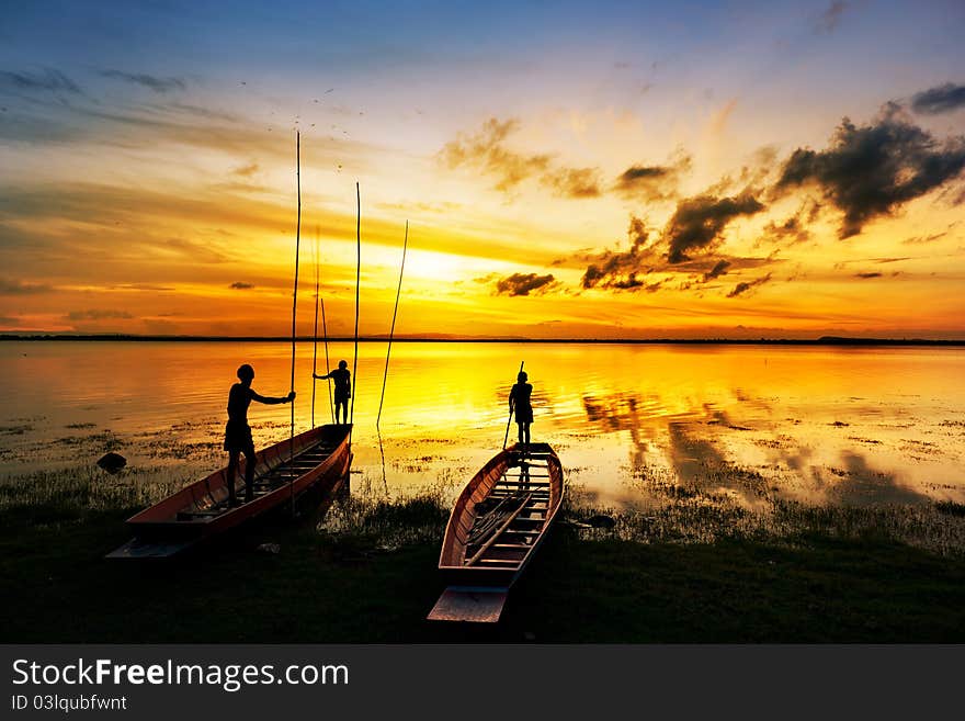 Silhouette of children on wood boat at sunset. Silhouette of children on wood boat at sunset