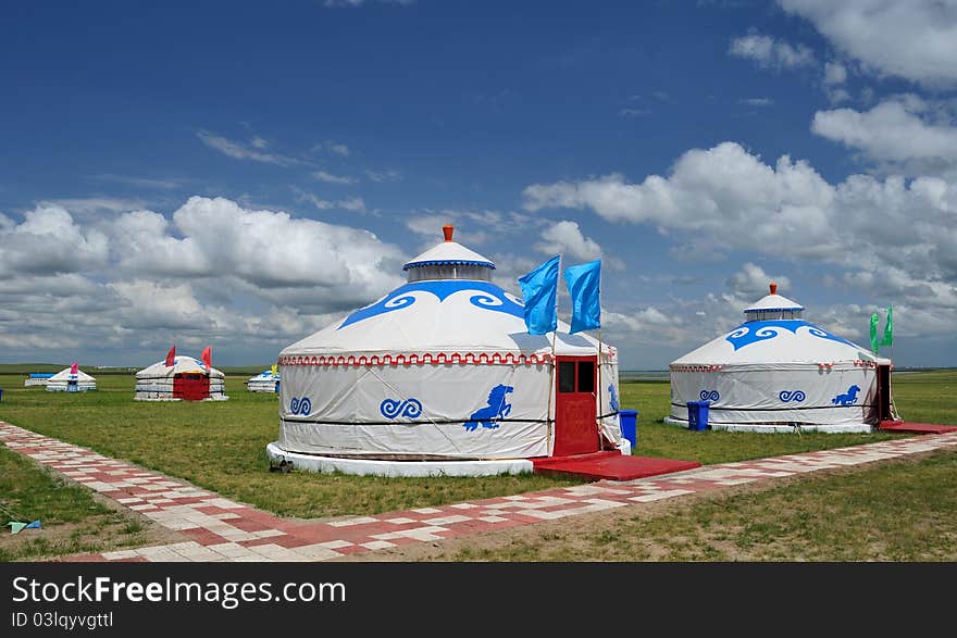 Mongolia packages with blue flags under blue sky and white clouds, beautiful. Mongolia packages with blue flags under blue sky and white clouds, beautiful.