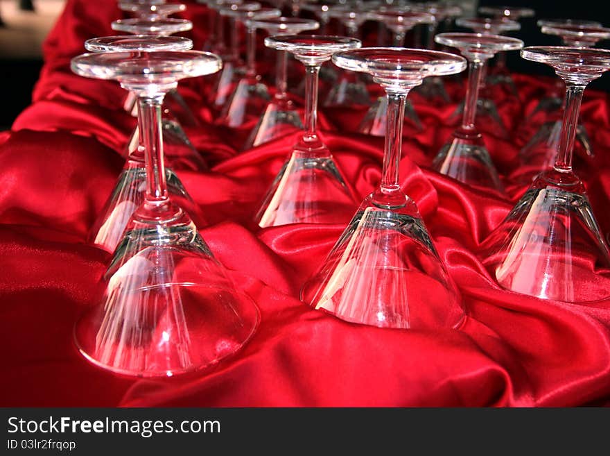 Footed tumblers upside down on the red cloth table restaurant