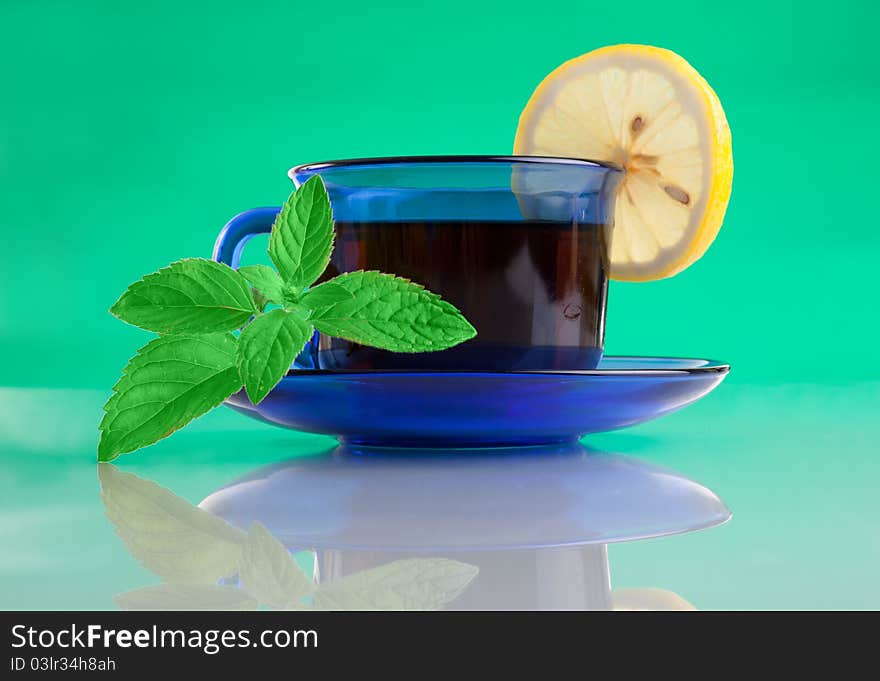 Nice Cup Of Tea And Mint On Green Background