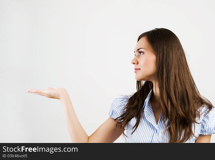 Happy smiling young business woman showing blank area for sign or copyspase, isolated on white background