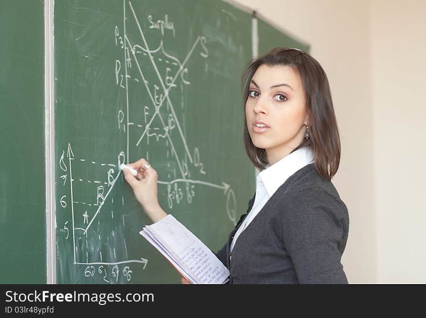 Female student is responsible with the synopsis near the boards in the University Auditorium