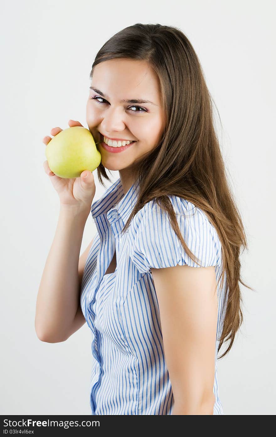 Beautiful Young Woman Biting A Green Apple