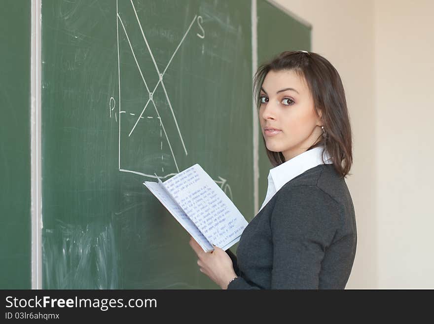 Female student is responsible with the synopsis near the boards in the University Auditorium