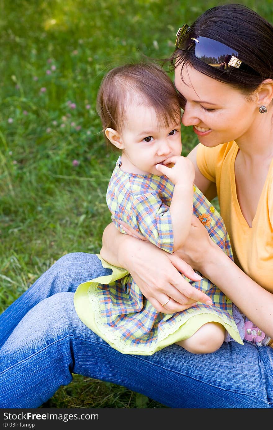 Happy mom with her daughter in a park. Happy mom with her daughter in a park