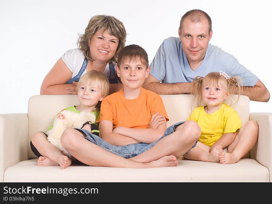 Portrit of a family sitting on sofa. Portrit of a family sitting on sofa