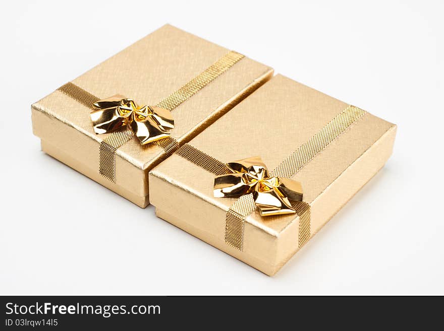 A pair of golden jewelry box isolated on white background