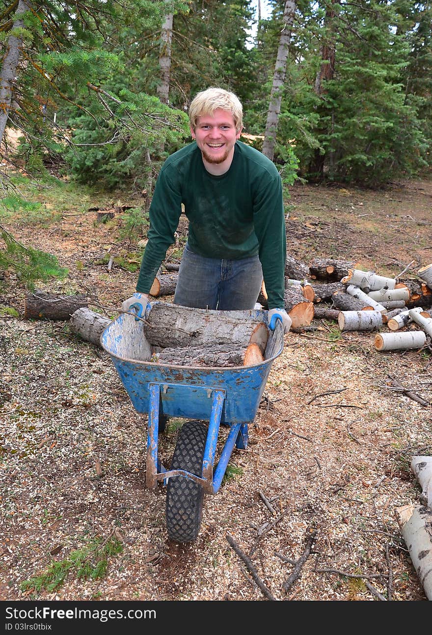 Teenage Boy With A Wheelbarrow In The Forest