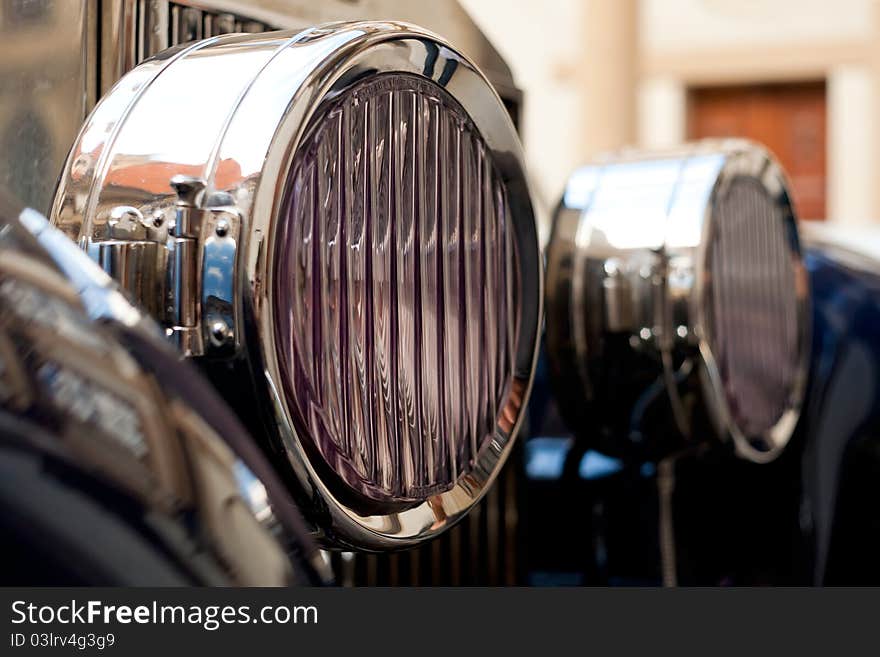 Closeup view on front lights of a really old vintage car. Closeup view on front lights of a really old vintage car